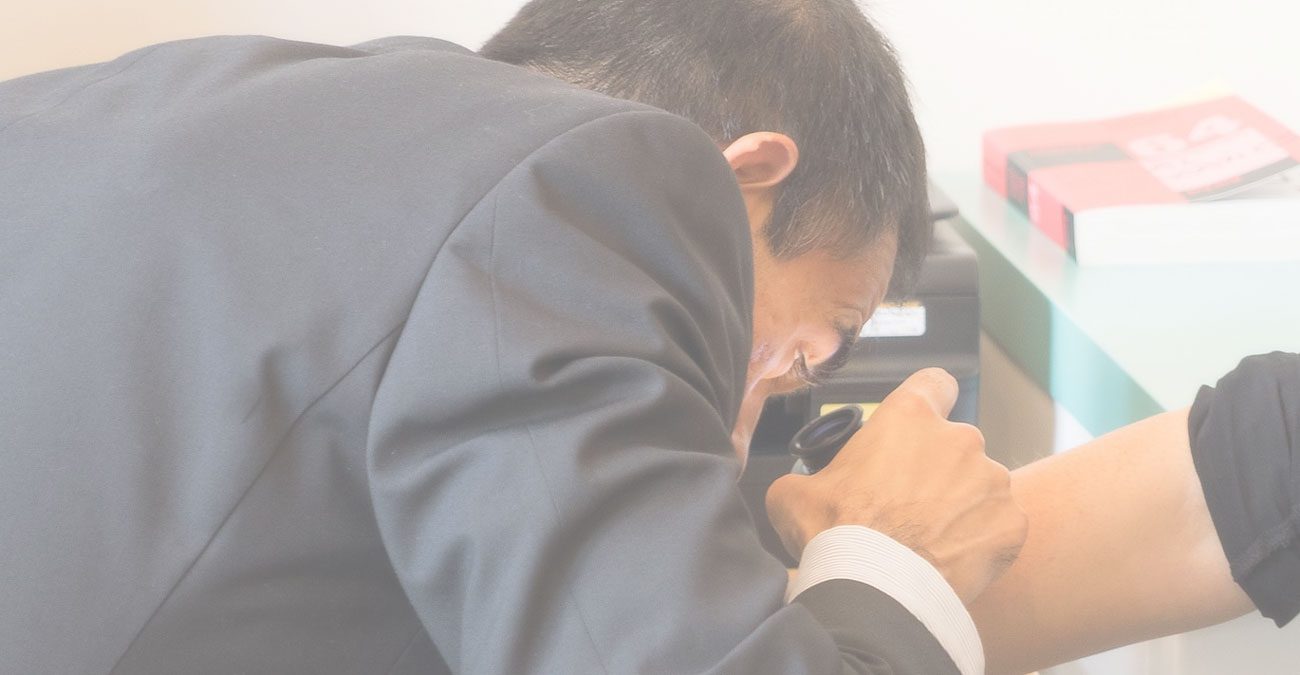 Dermatologist examining a patient's skin with a dermatoscope